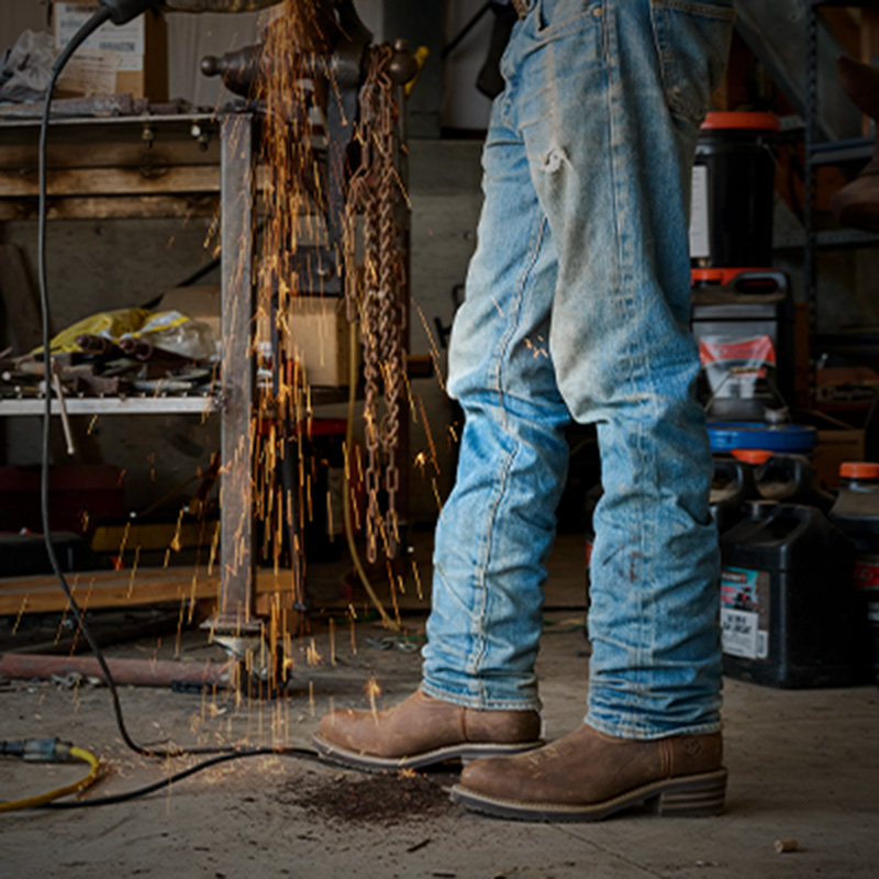 A worker wearing the Garza Comp Toe in brown.