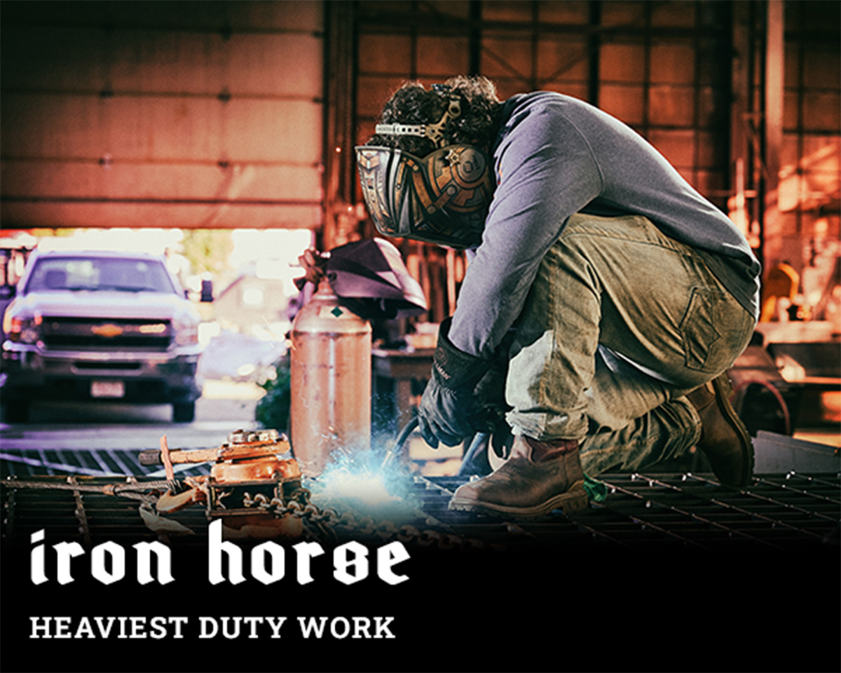 Iron horse. Heaviest duty work. A man welding and wearing the brock comp toe in brown.