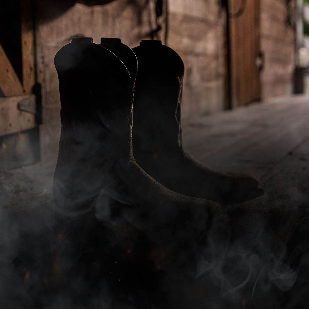 A pair of Double-H boots obscured by smoke.