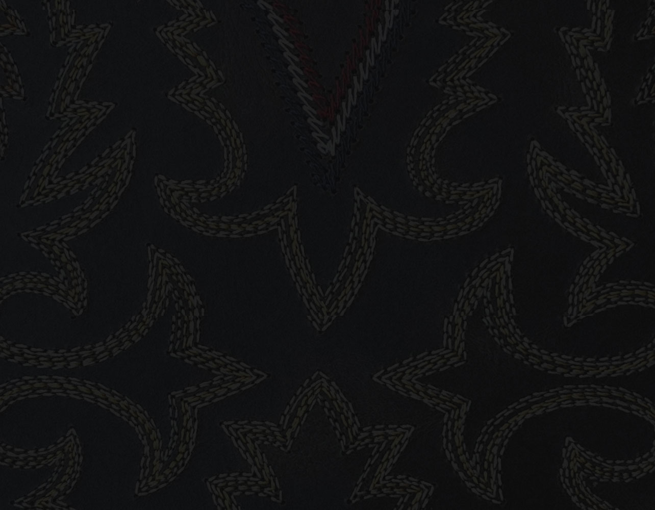 A close-up of western boot stitching.