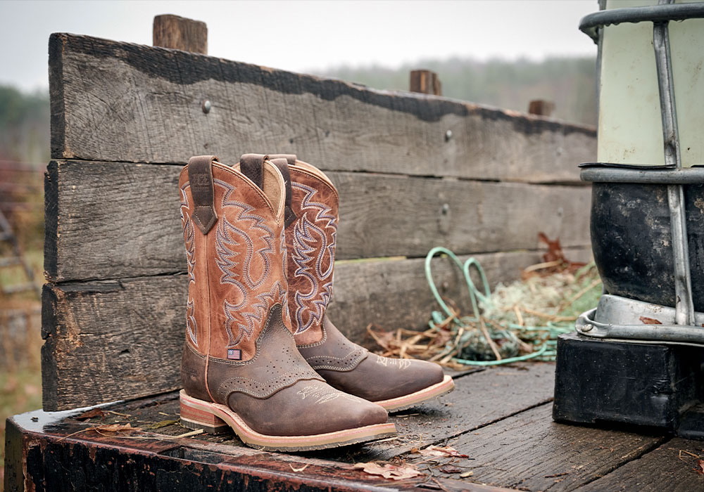 The Fernandez western boots in brown sitting on the back of a tractor.