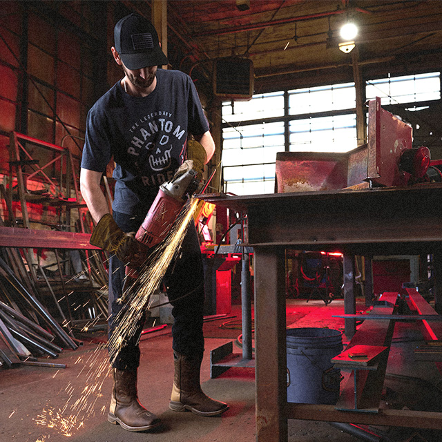 A welder wearing the malign western boot in brown.