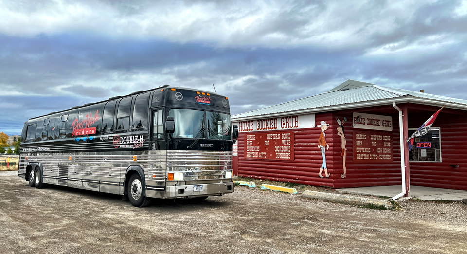 Doo Wah Riders bus outside a store. 