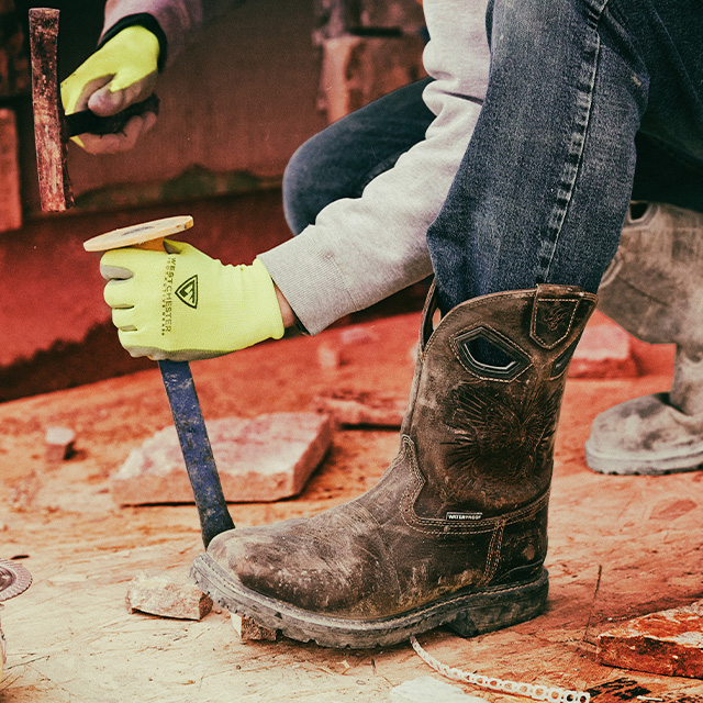 A man working and wearing the Dustie Comp Toe boot in brown.