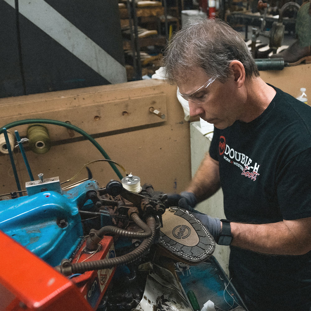 A factory worker making a Double-H boot.
